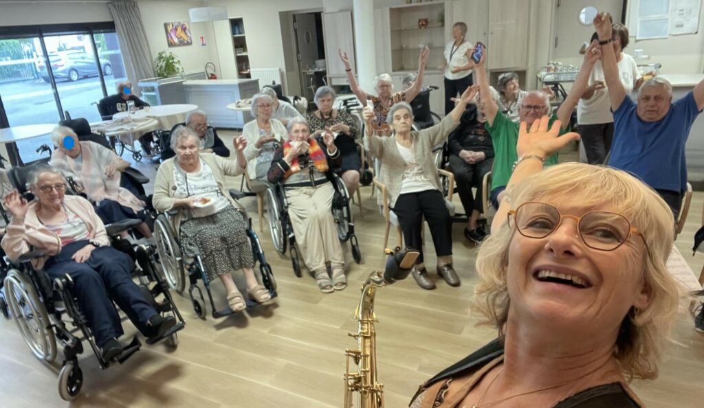 Saxophoniste en pleine performance devant les familles réunies.